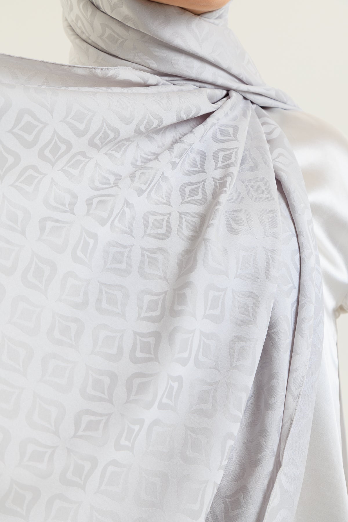 Light gray patterned fabric with a plain background